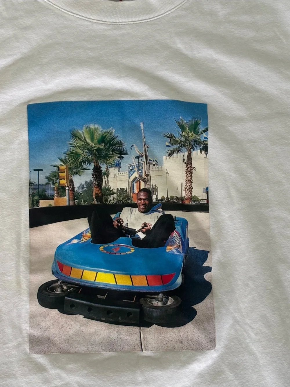 Jordan white graphic tee with Michael Jordan in a bumper car.